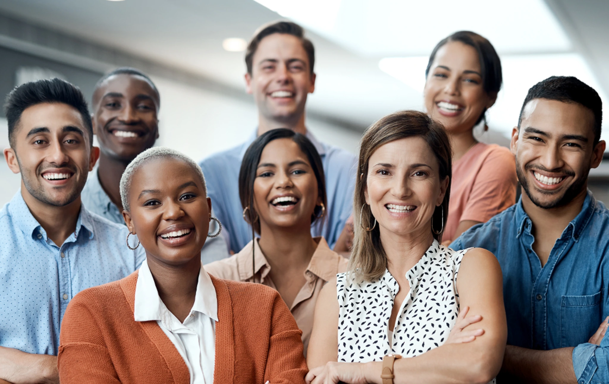 A diverse group of professionals smiling confidently at the camera.