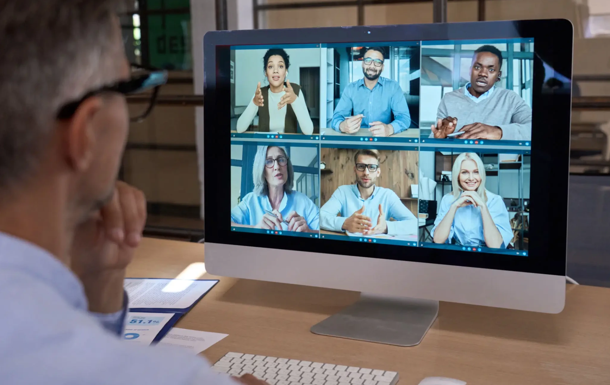 People engaged in a virtual meeting on a computer screen.